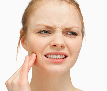 woman massaging her cheek