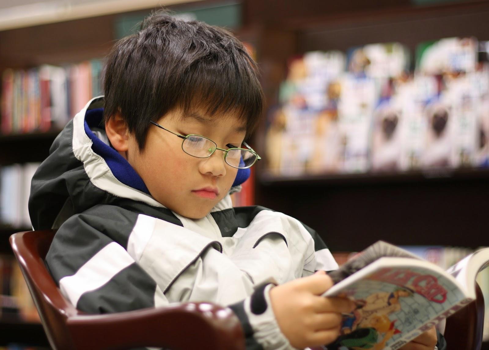 Young_boy_reading_manga - كيف يغير التعليم الصحيح العالم