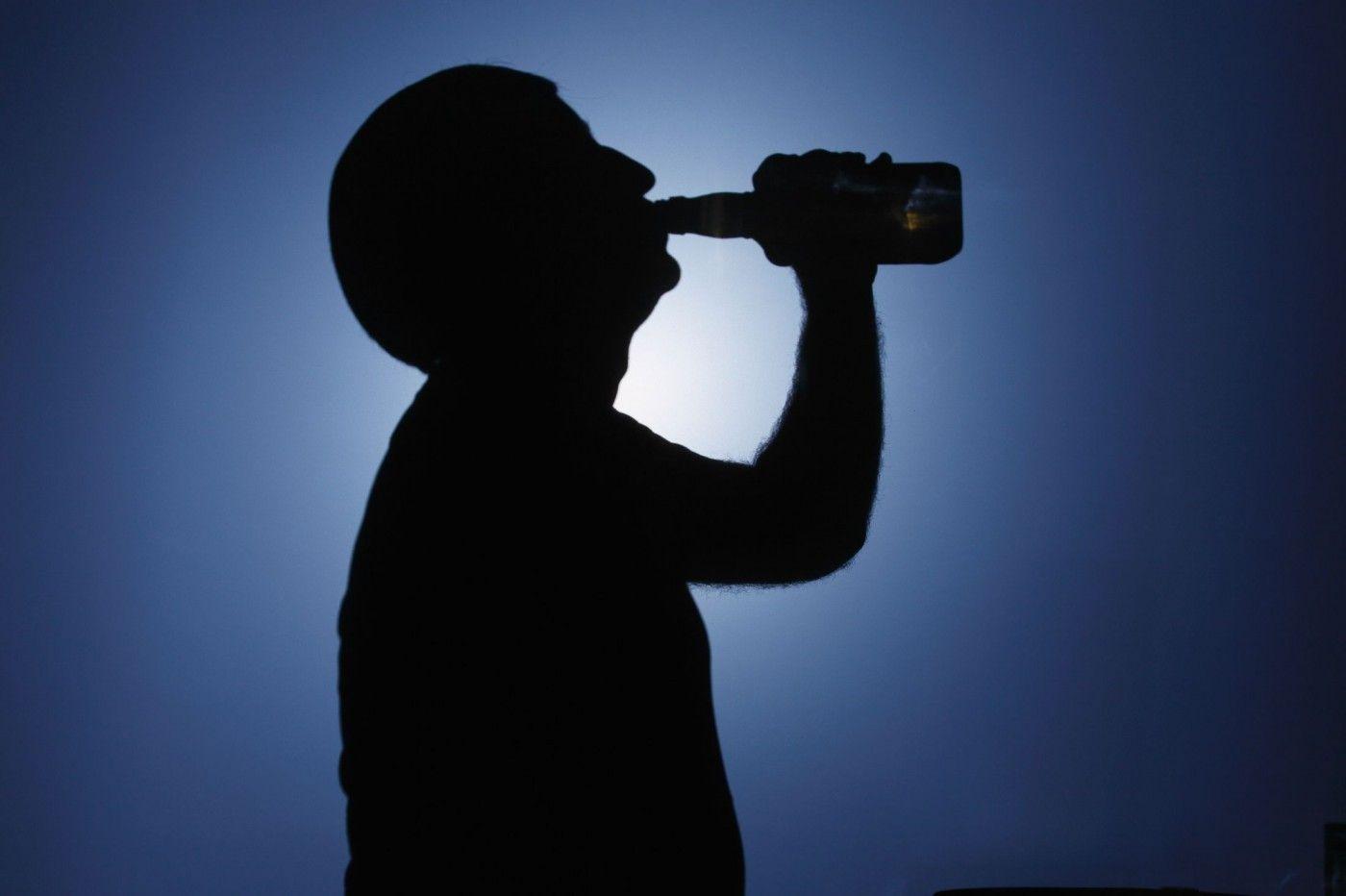 Silhouette of man drinking alcohol