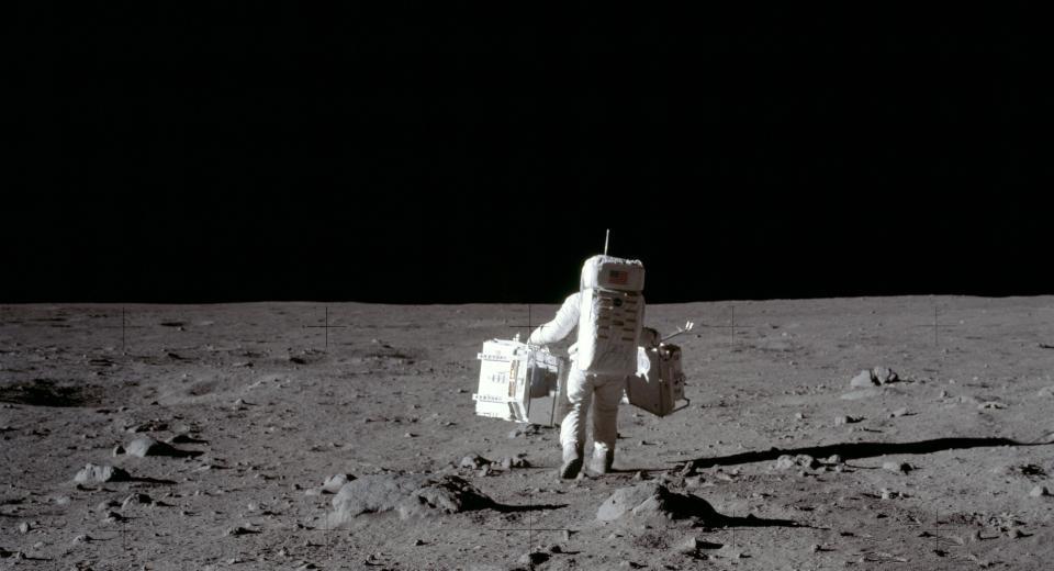 An astronaut walking on the moon</p>
<p>Description automatically generated