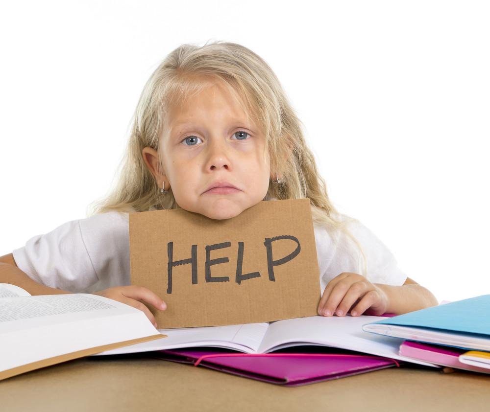 sweet little blonde hair school girl holding help sign in stress with books and homework in children education concept isolated on white background