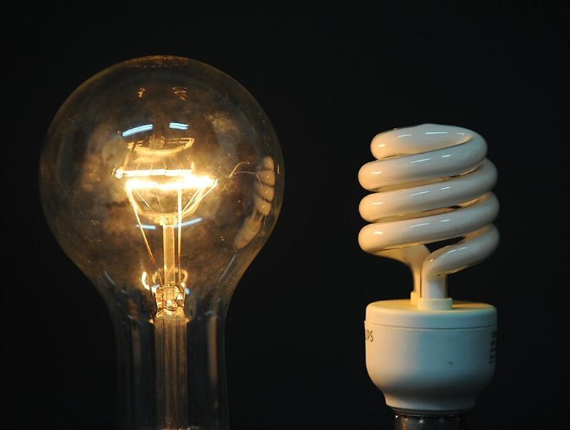 a_traditional_incandescent_light_bulb_and_its_low__485f489caa22