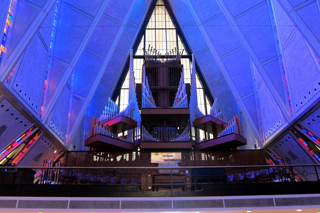 The classical pipe organ in the Protestant Chapel of Cadet Chapel at the United States Air Force Academy was designed by Walter Holtkamp and built by the M.P. Moller Company. Perched high in the choir loft, the organ has 83 ranks and 67 stops, controlling 4,334 pipes, ranging in size from 32 feet high to merely pencil-like size. Two chests sit to the right and left--the Positive division and the pipes of the pedal, respectively. In the center lower area is the Great pipework. Above it are two chambers housing the Swell division. Crowning the structure are the large Trompetas.